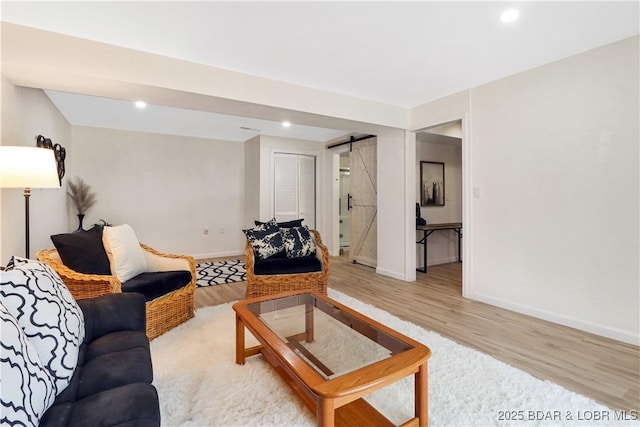 83 Archer Dr, Camdenton, MO 65020 - living room with recessed lighting, a barn door, light wood-style floors, and baseboards