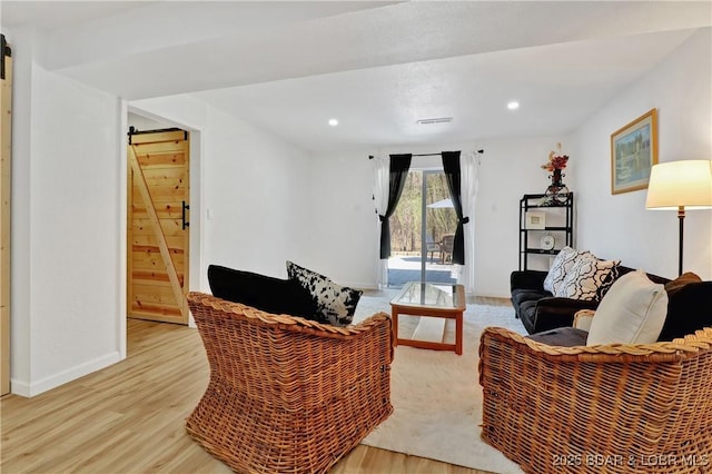 83 Archer Dr, Camdenton, MO 65020 - living area with light wood-type flooring, recessed lighting, baseboards, and a barn door