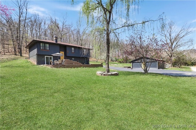83 Archer Dr, Camdenton, MO 65020 - view of yard featuring an outbuilding, a garage, and driveway