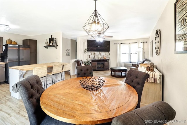 83 Archer Dr, Camdenton, MO 65020 - dining room with light wood finished floors and a fireplace