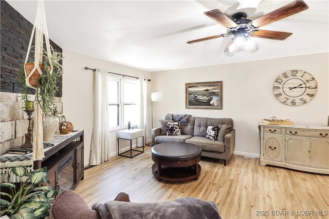 83 Archer Dr, Camdenton, MO 65020 - living area featuring light wood finished floors, baseboards, a ceiling fan, and a fireplace