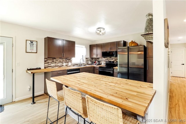 83 Archer Dr, Camdenton, MO 65020 - kitchen featuring black microwave, freestanding refrigerator, decorative backsplash, and electric stove