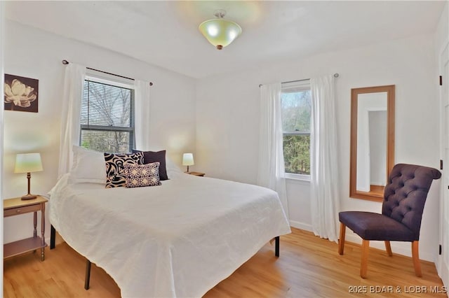 83 Archer Dr, Camdenton, MO 65020 - bedroom with baseboards, multiple windows, and light wood finished floors