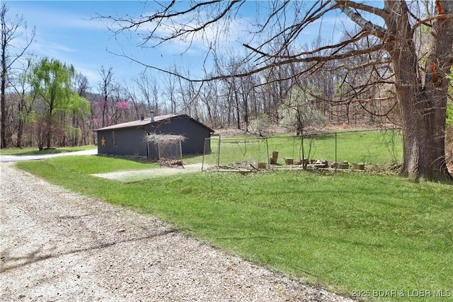 83 Archer Dr, Camdenton, MO 65020 - view of yard featuring a wooded view, fence, and gravel driveway