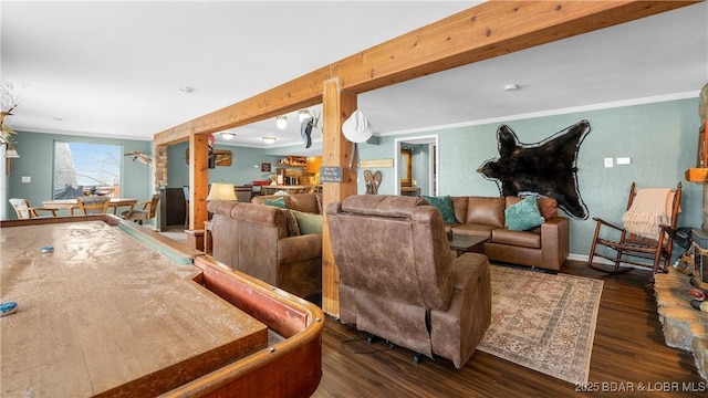 living room featuring ornamental molding, wood finished floors, and beamed ceiling
