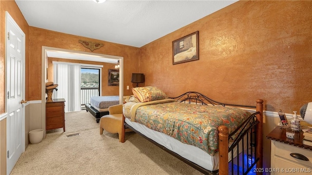 bedroom featuring visible vents, access to outside, and carpet flooring