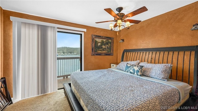 bedroom featuring access to exterior and a ceiling fan