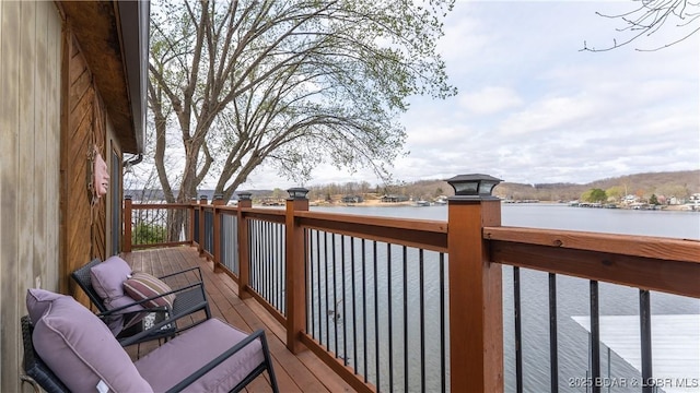 wooden terrace featuring a water view