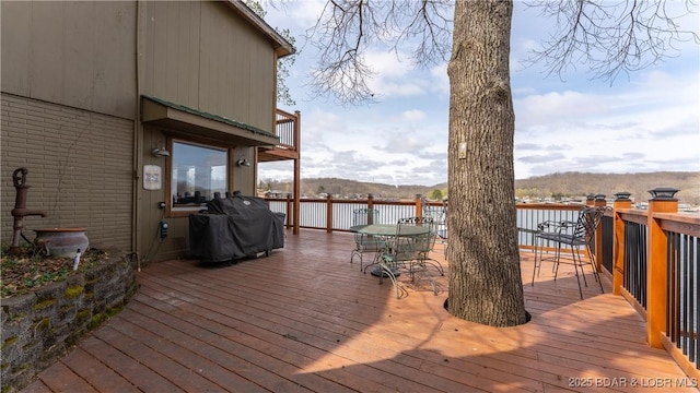 wooden terrace featuring a grill