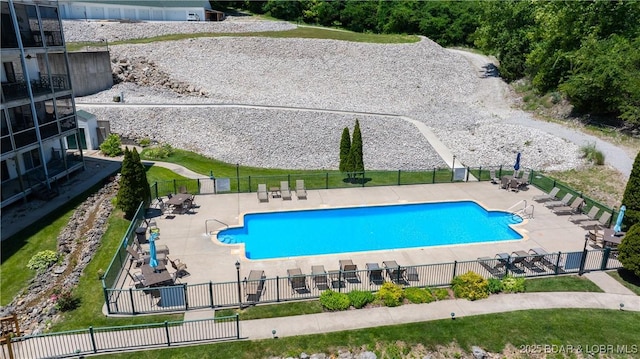 community pool featuring fence and a patio area