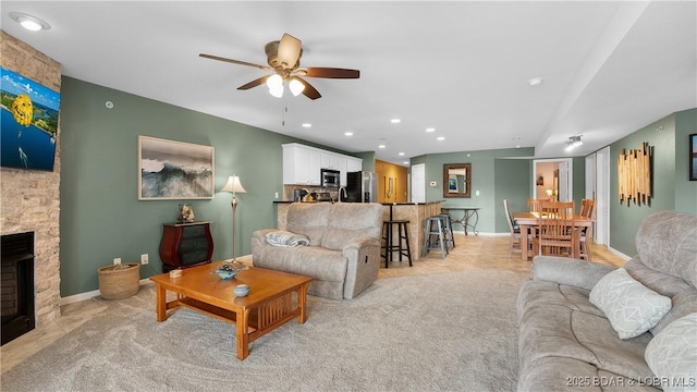 364 Cedar Heights Dr Unit 2B, Camdenton, MO 65020 - living area with ceiling fan, recessed lighting, a stone fireplace, and light carpet