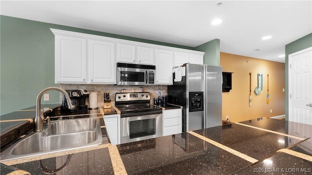 364 Cedar Heights Dr Unit 2B, Camdenton, MO 65020 - kitchen with appliances with stainless steel finishes, white cabinets, tasteful backsplash, and recessed lighting