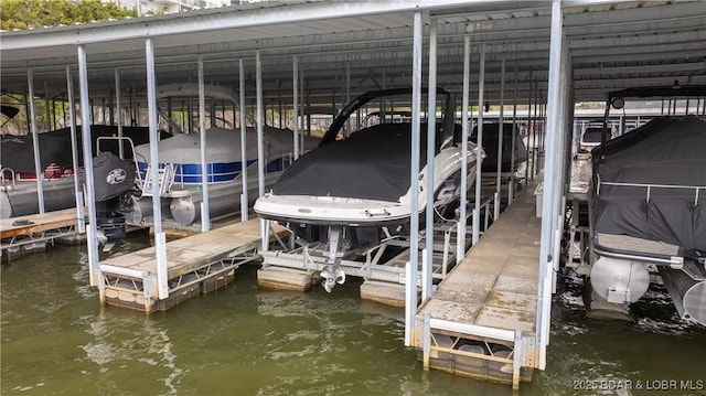 view of dock featuring boat lift and a water view