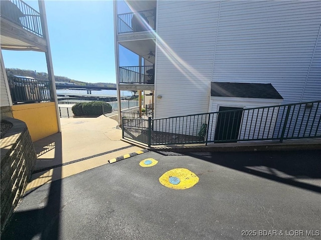 view of patio / terrace featuring a water view and a balcony
