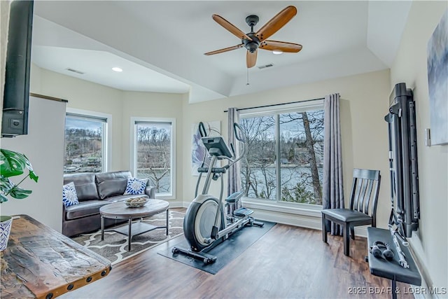 exercise area featuring ceiling fan, wood finished floors, baseboards, and recessed lighting