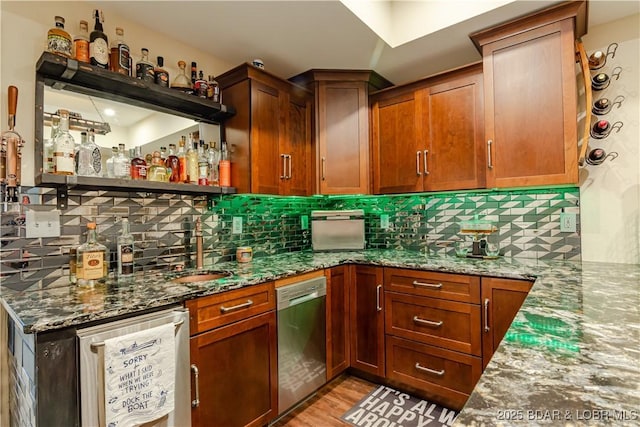 indoor wet bar featuring dishwasher, decorative backsplash, and light wood-type flooring