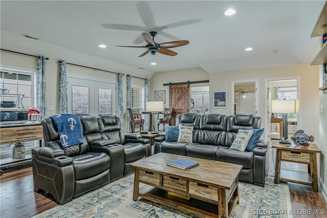 living area featuring ceiling fan, a barn door, plenty of natural light, wood finished floors, and recessed lighting