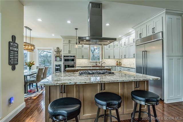 kitchen with stainless steel appliances, island range hood, dark wood-type flooring, backsplash, and recessed lighting
