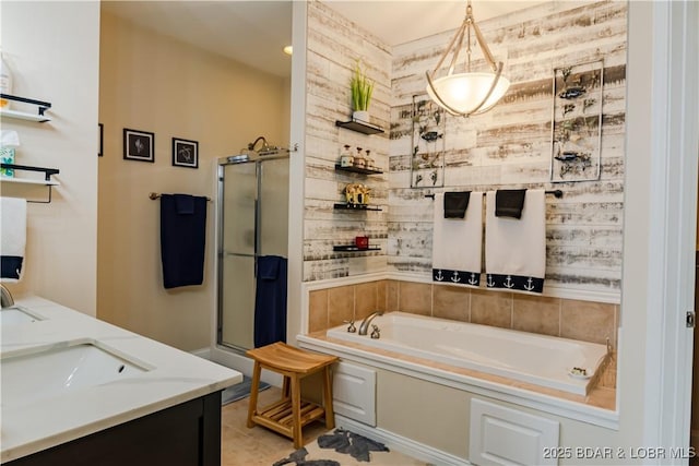 full bath with a stall shower, a bath, and a sink