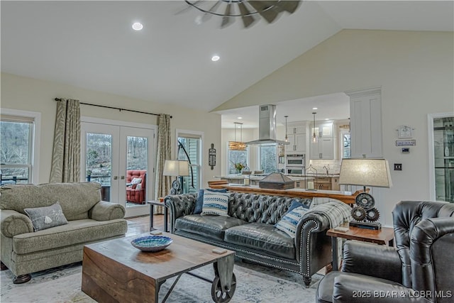 living room featuring french doors, high vaulted ceiling, and recessed lighting