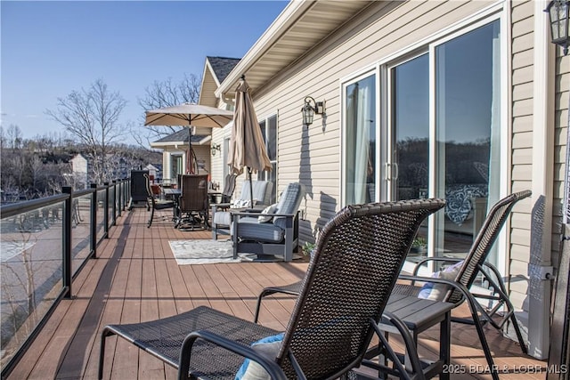 wooden terrace with outdoor dining space