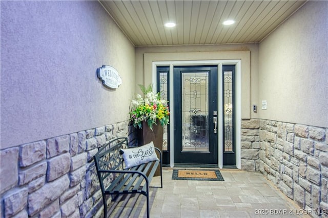 doorway to property featuring stucco siding