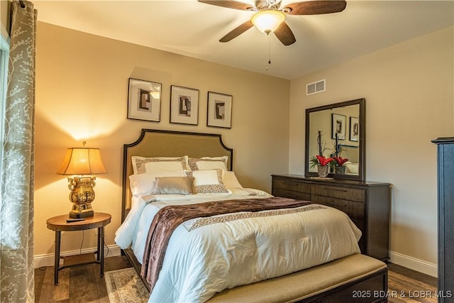 bedroom featuring baseboards, wood finished floors, and ceiling fan