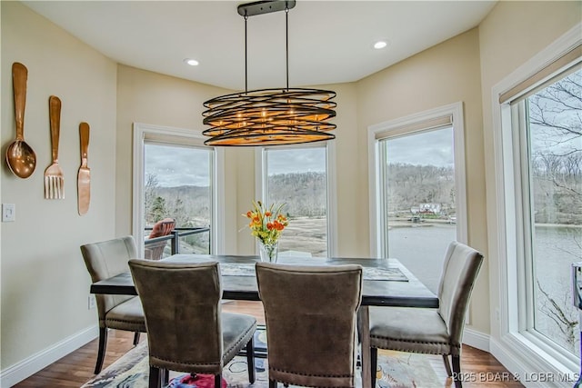 dining room with plenty of natural light, a chandelier, dark wood finished floors, baseboards, and recessed lighting