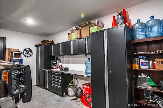 kitchen featuring dark cabinets and unfinished concrete floors