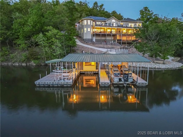 dock area featuring boat lift and a water view