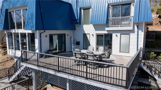 deck featuring stairway, central AC, and outdoor dining space