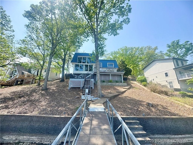 rear view of property with stairway