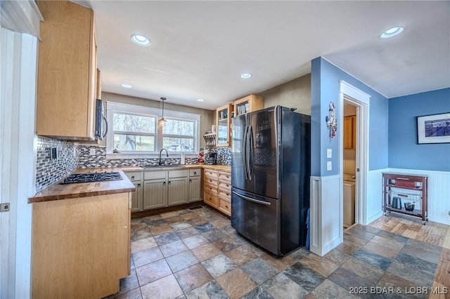 33724 Ivy Bnd, Stover, MO 65078 - kitchen with a sink, backsplash, appliances with stainless steel finishes, and hanging light fixtures