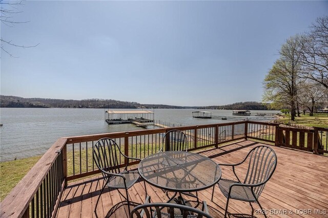 33724 Ivy Bnd, Stover, MO 65078 - deck with a water view, a boat dock, and outdoor dining space