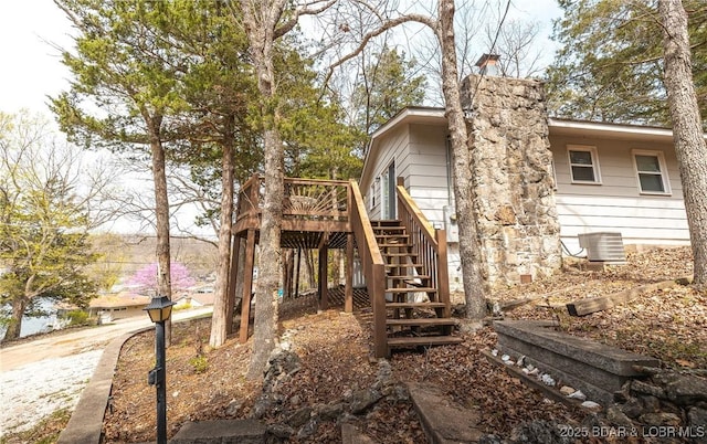 29829 Sheldy Dr, Rocky Mount, MO 65072 - view of home's exterior with stairway, a deck, and a chimney