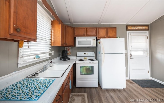 29829 Sheldy Dr, Rocky Mount, MO 65072 - kitchen featuring white appliances, light countertops, dark wood-type flooring, brown cabinetry, and a sink
