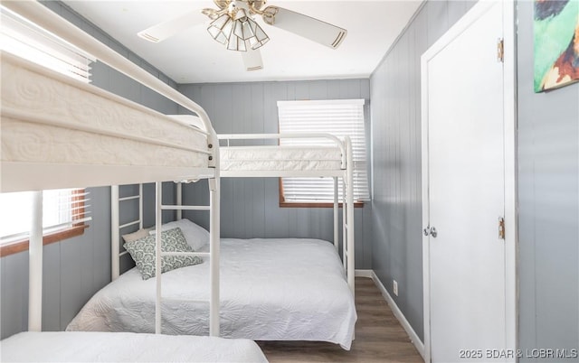 29829 Sheldy Dr, Rocky Mount, MO 65072 - bedroom with wood walls, multiple windows, and wood finished floors