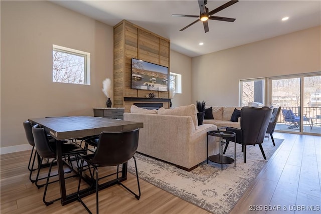 613 Cove Cir, Sunrise Beach, MO 65079 - living area featuring light wood-type flooring, a fireplace, a ceiling fan, plenty of natural light, and recessed lighting