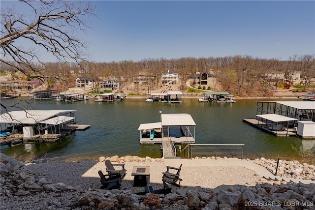 613 Cove Cir, Sunrise Beach, MO 65079 - dock with a water view and an outdoor fire pit
