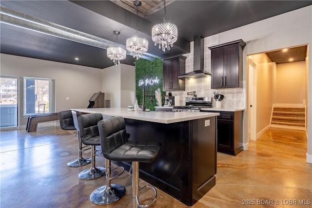 613 Cove Cir, Sunrise Beach, MO 65079 - kitchen with wall chimney exhaust hood, stainless steel range with electric cooktop, tasteful backsplash, finished concrete flooring, and light countertops