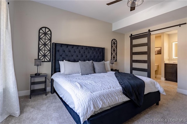 613 Cove Cir, Sunrise Beach, MO 65079 - bedroom with a barn door, light carpet, and baseboards