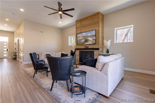 613 Cove Cir, Sunrise Beach, MO 65079 - living area featuring a fireplace, light wood-type flooring, plenty of natural light, and recessed lighting