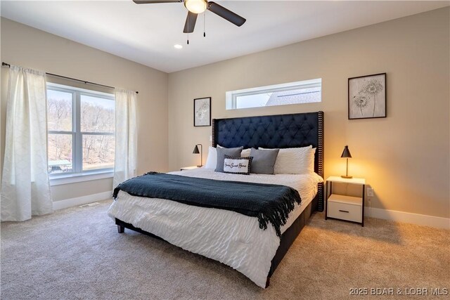 613 Cove Cir, Sunrise Beach, MO 65079 - carpeted bedroom featuring multiple windows, baseboards, and a ceiling fan