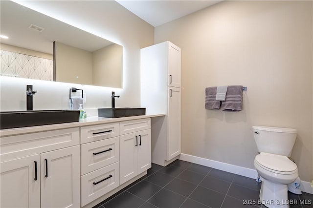 613 Cove Cir, Sunrise Beach, MO 65079 - bathroom featuring baseboards, toilet, tile patterned floors, and double vanity