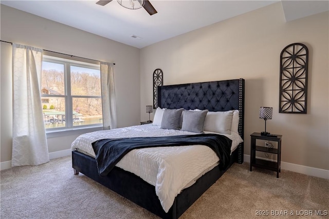613 Cove Cir, Sunrise Beach, MO 65079 - bedroom featuring carpet, baseboards, and a ceiling fan