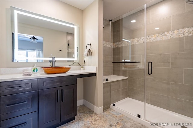 613 Cove Cir, Sunrise Beach, MO 65079 - bathroom featuring a ceiling fan, a stall shower, baseboards, and vanity