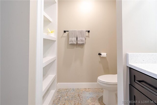 613 Cove Cir, Sunrise Beach, MO 65079 - bathroom with toilet, baseboards, vanity, and tile patterned floors