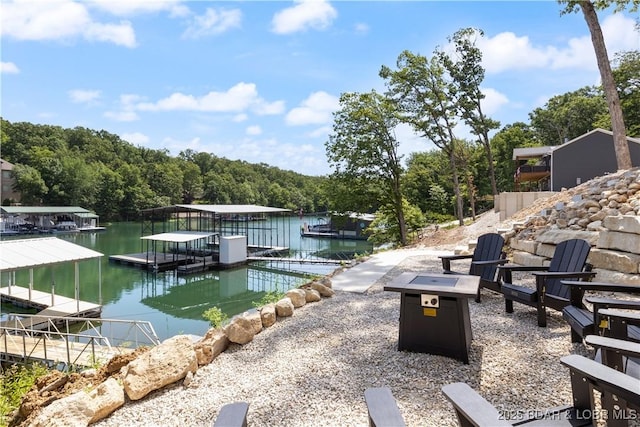 613 Cove Cir, Sunrise Beach, MO 65079 - dock featuring a water view, a fire pit, and a view of trees