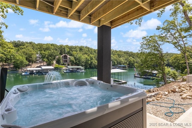 613 Cove Cir, Sunrise Beach, MO 65079 - view of patio / terrace with a water view, a hot tub, and view of wooded area