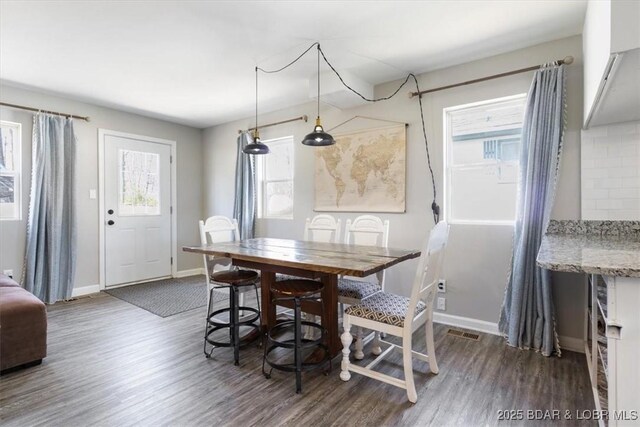 34524 Ivy Bend Rd, Stover, MO 65078 - dining area featuring dark wood finished floors and baseboards